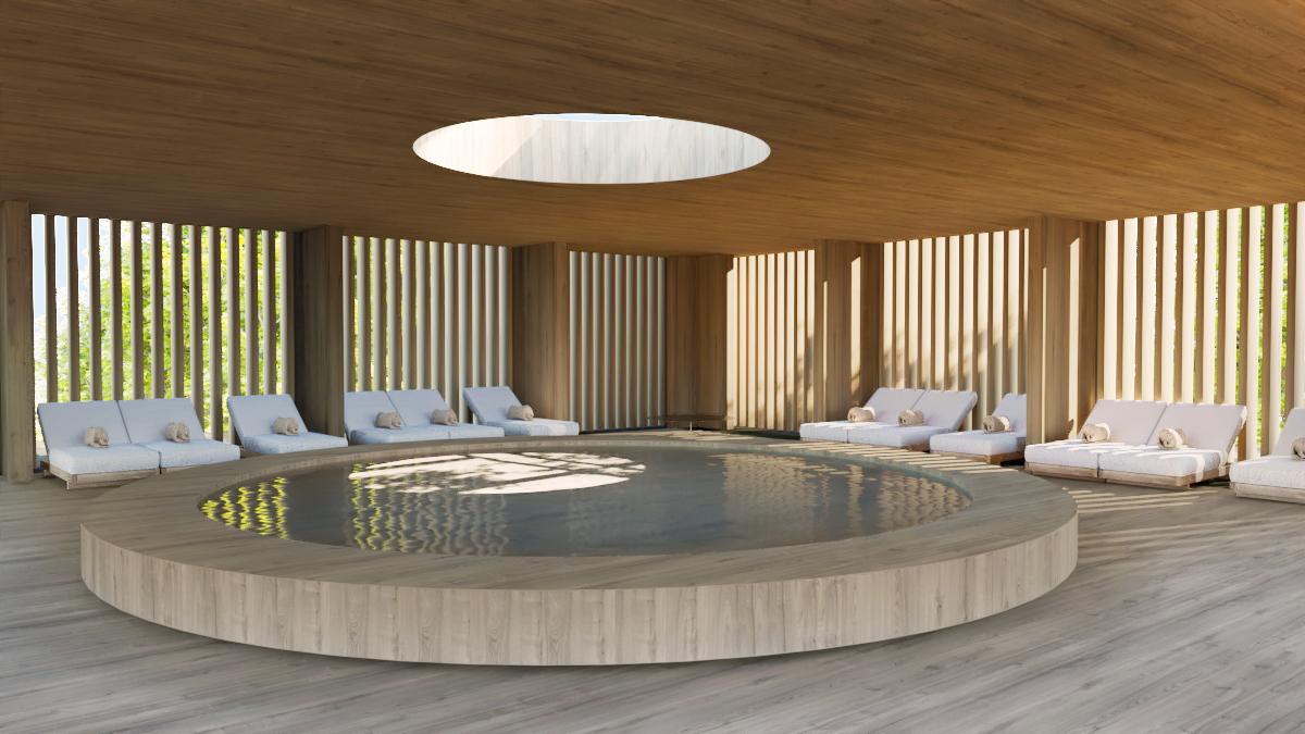 The large circular bathing pool at the AMAIA hotel spa — drawn from hammam tradition, lit from above.