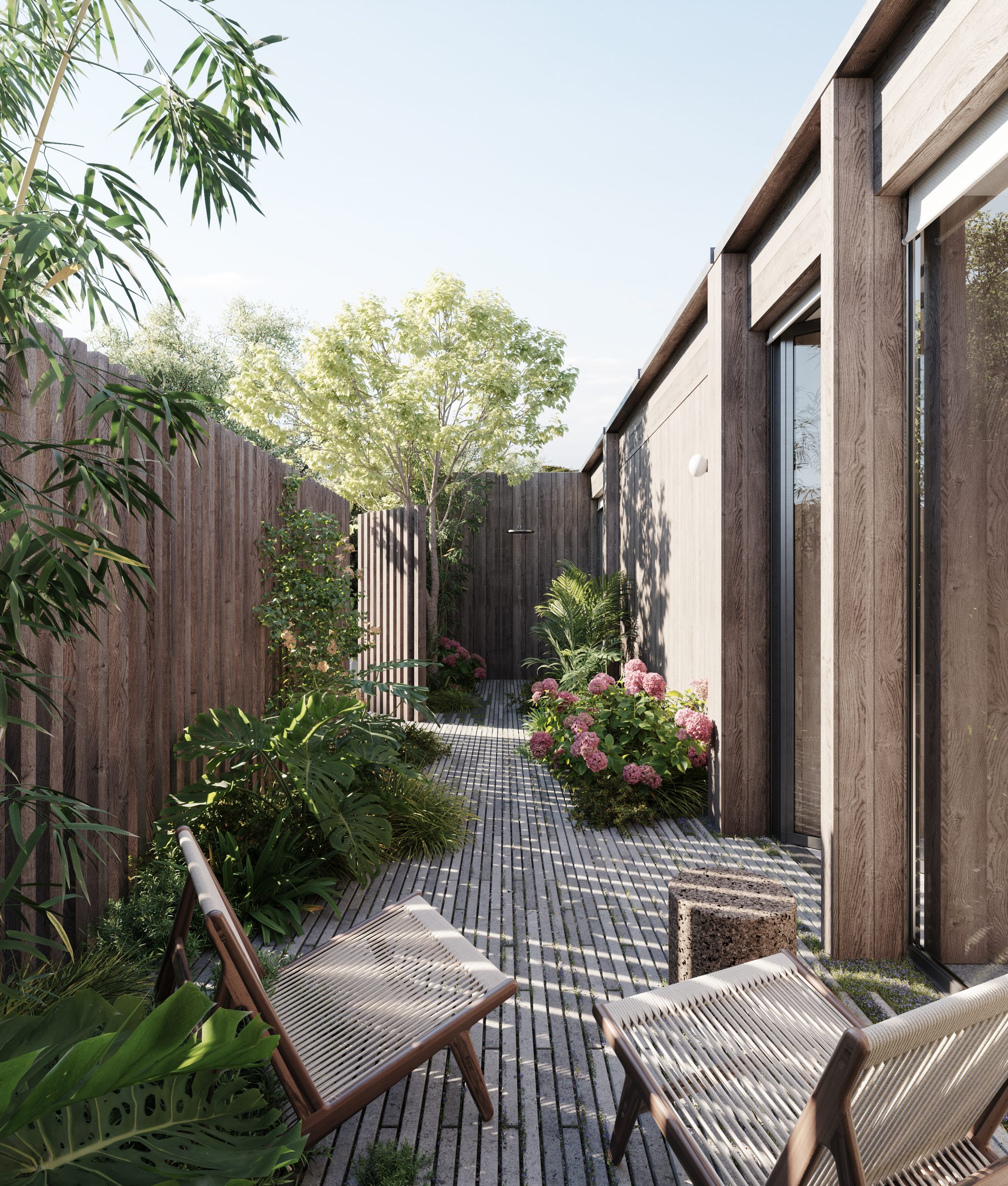 The walled timber entrance to a suite at the AMAIA hotel, planted with bamboo and hydrangeas.